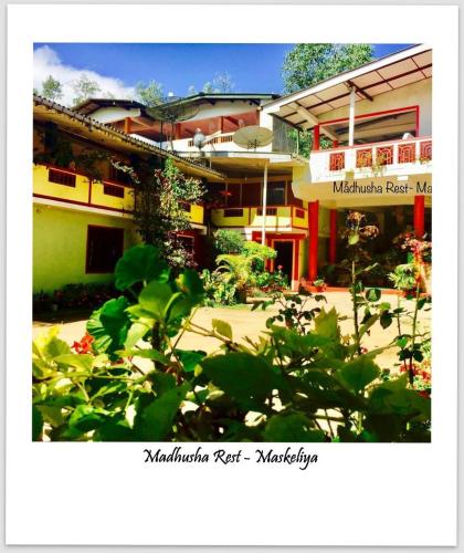 a building with a lot of plants in front of it at Madhusha Rest in Maskeliya