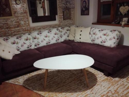 a living room with a couch and a table at Seosko turističko domacinstvo Imunsan in Niš