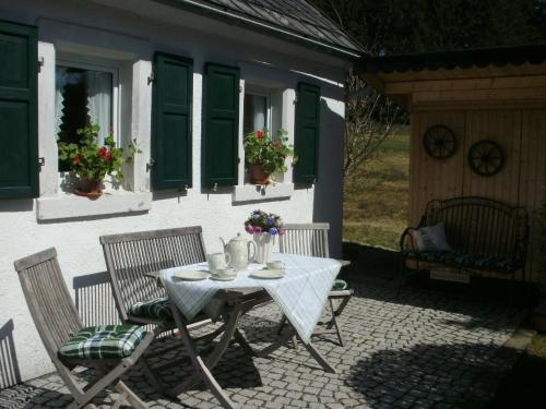 a table and chairs on the patio of a house at Gasthof Bischofsmühle in Helmbrechts