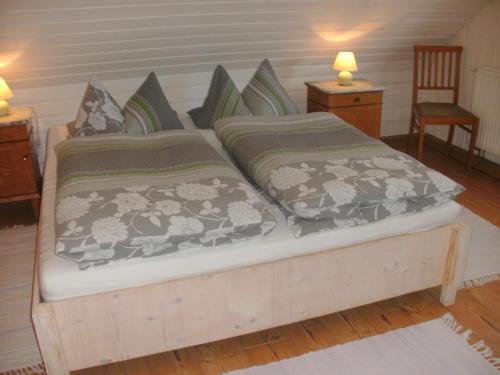 a bed in a room with two pillows at Gasthof Bischofsmühle in Helmbrechts