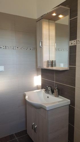 a bathroom with a sink and a mirror at Villa Danae in Gaios