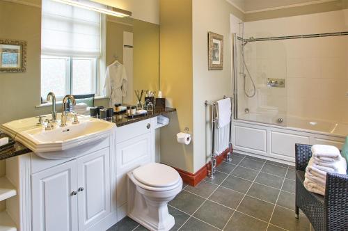 a bathroom with a toilet and a sink and a shower at Fairfield House in Warkworth