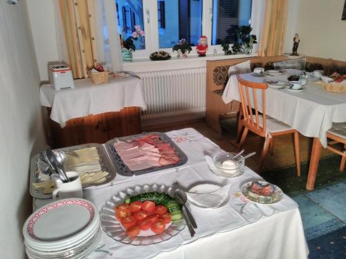 a table with a plate of food on it at Haus Amalia in Strobl