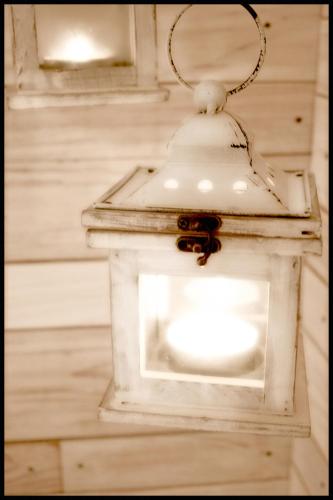 a white lantern hanging from a wall at Casa Vacanze Borc dai Cucs in Faedis