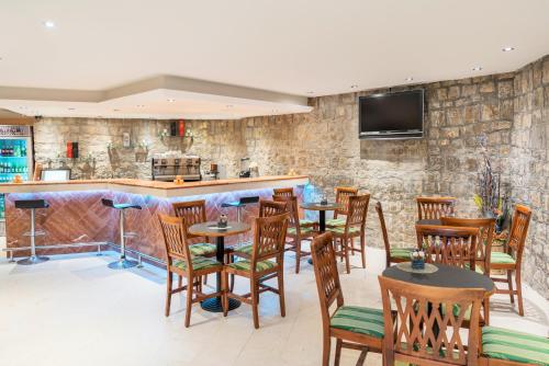 a kitchen area with a table and chairs at Iberostar Bellevue - All Inclusive in Budva