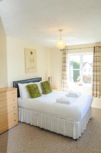 a bedroom with a large white bed with a window at Orchard Gate Apartments from Your Stay Bristol in Bristol