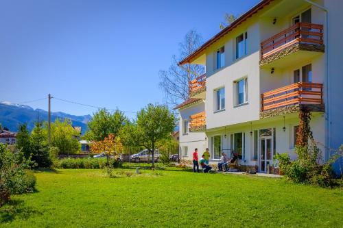 a group of people standing outside of a building at Atanasovata Kashta in Govedartsi