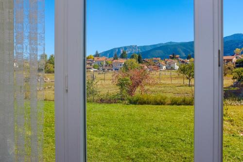 a window with a view of a field at Atanasovata Kashta in Govedartsi