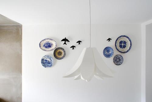 a group of blue and white plates on a wall at Casa do Meio in Coimbra