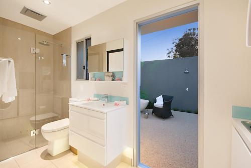 a bathroom with a sink and a toilet and a shower at Cavvanbah - Byron Bay in Byron Bay