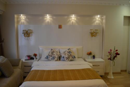 a bedroom with a white bed and white pillows at Peradise Hotel in Istanbul