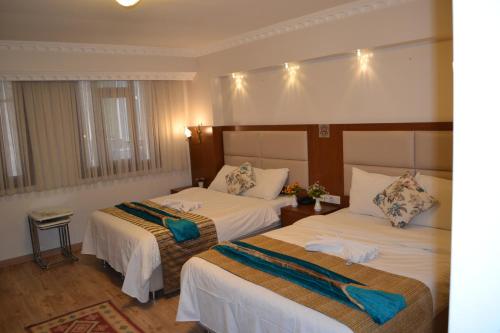Säng eller sängar i ett rum på Peradise Hotel