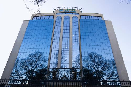 a tall building with a lot of windows at Lotos Inn & Suites, Nairobi in Nairobi