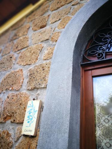 a sign on a stone wall next to a door at Podere La Branda in Vetralla