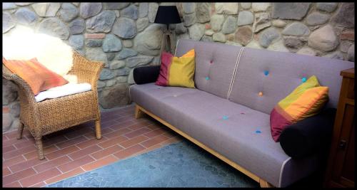 a couch with colorful pillows sitting in a room at Casa Vacanze Borc dai Cucs in Faedis
