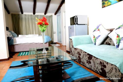 a living room with a couch and a glass table at Harmony Guest House in Johannesburg