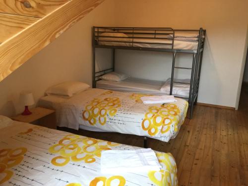 a bedroom with two bunk beds and a staircase at Residencial Avenida Hostel in Tomar