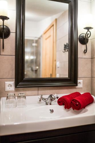 a bathroom sink with a mirror and a red towel at Knusperhauschen Sonnegg in Flachau