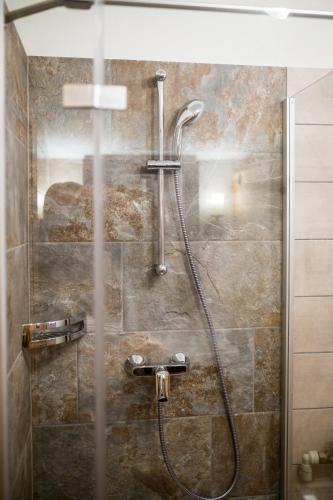 a bathroom with a shower with a glass door at Knusperhauschen Sonnegg in Flachau