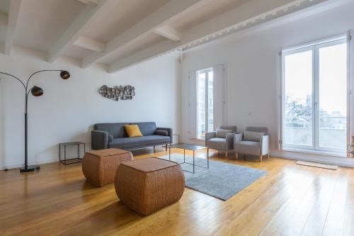 a living room with two couches and a table at Oporto City View - Santa Catarina in Porto