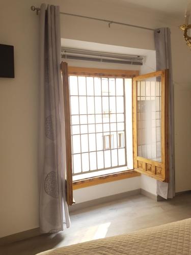 a bedroom with a large window in a room at Casa Botes in Cuenca