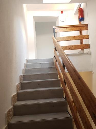 a staircase in a house with a wooden railing at Casa Botes in Cuenca