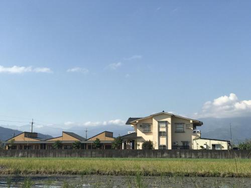 a house with a fence in front of it at Easy Home Stay in Xingjian