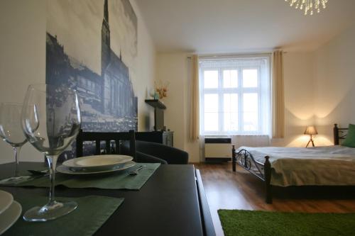 a living room with a dining table and a bed at Apartmán Mrakodrap in Plzeň