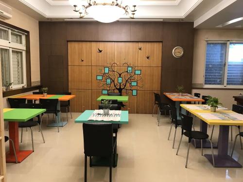a dining room with tables and chairs and a chandelier at Easy Home Stay in Xingjian