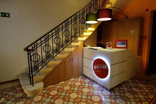 a staircase in a building with a soda machine at Corner Hostel in Sliema