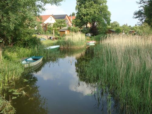 a couple of boats sitting in the water at Hotel am Wariner See in Warin