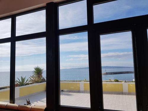 a view of the ocean from a window at Villarolu in Portoscuso