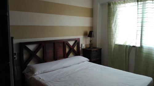 a bedroom with a bed and a window at Apartamento en 1ª LINEA Playa de Gandia in Gandía