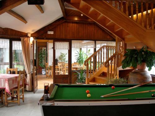 a pool table in a living room with a staircase at Hosteria Catalana in Bossost