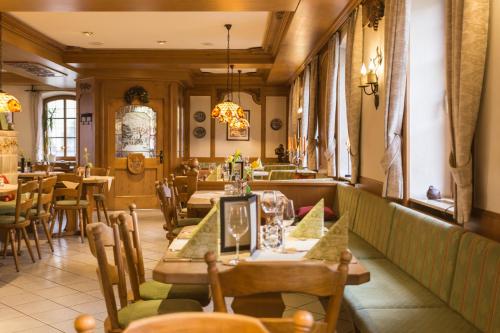a restaurant with tables and chairs in a room at Hotel Löwen in Randersacker