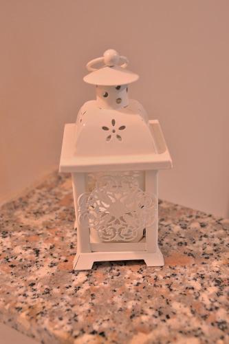a small toy jar with a hat on a table at B&B Al Sole di Sicilia in Giardini Naxos