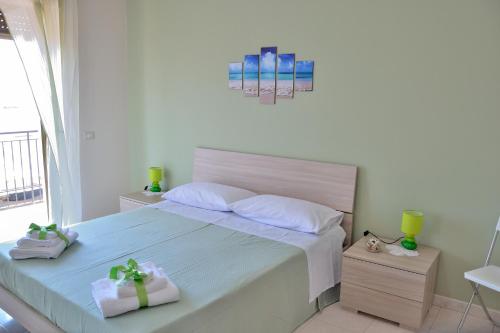 a bedroom with a bed with two boxes on it at B&B Al Sole di Sicilia in Giardini Naxos