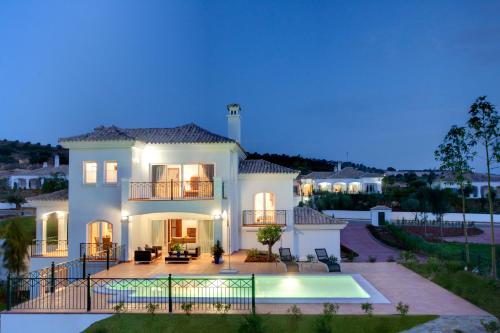 a villa with a swimming pool at night at Arcos Gardens Sol Rent Golf in Arcos de la Frontera