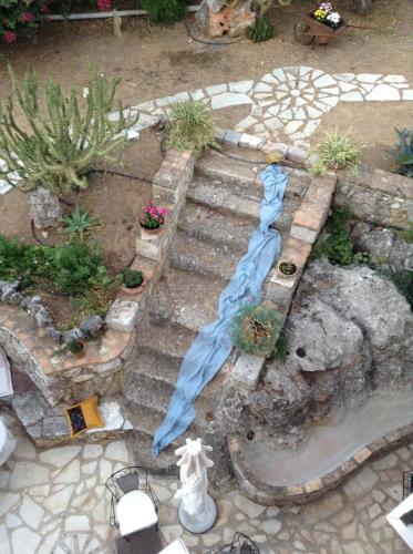 a model of a garden with a blue umbrella at Archontiko Art Hotel in Galaxidhion