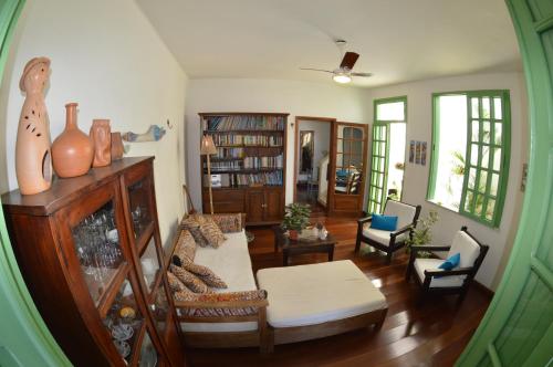 a living room with a couch and bookshelves at Pousada Baluarte in Salvador