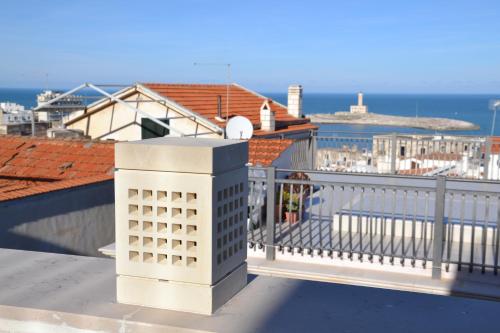 a balcony with a view of a city and the ocean at Cuore di Vieste in Vieste