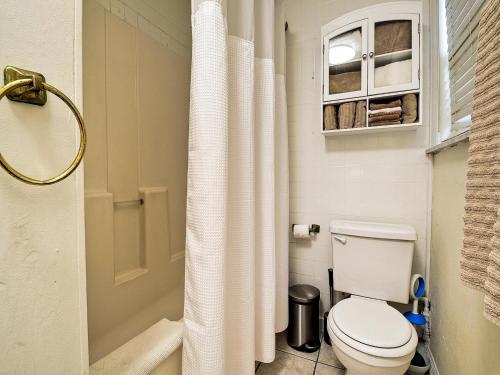 a bathroom with a toilet and a white shower curtain at Palm Place 3 - Buccaneer Palm Beach getaway 622 in Clearwater Beach