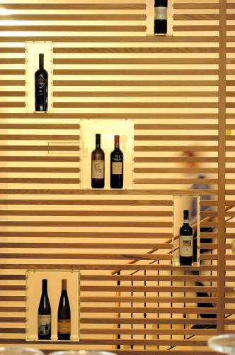 a wall with four bottles of wine on it at Hotel Melodia del Bosco in Badia
