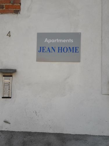 a sign on the side of a white building at Jean Home in Gallarate