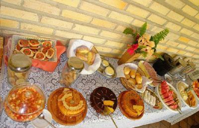 a table topped with different types of pastries and desserts at Eurosol Pousada das Canoas in Pipa