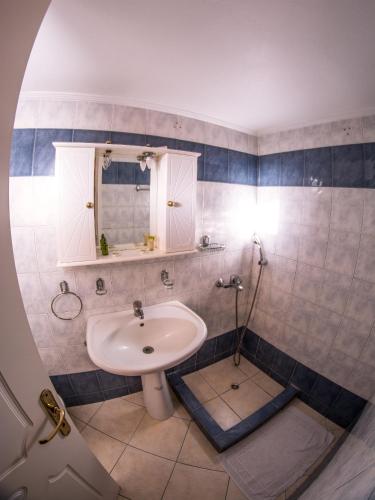 a bathroom with a sink and a mirror at Vagia Beach Apartments, Aegina Island in Vaia