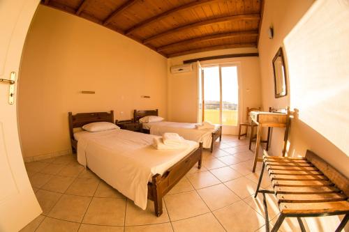 a hospital room with two beds and a window at Vagia Beach Apartments, Aegina Island in Vaia