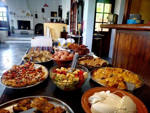 a table topped with lots of different types of food at Vagia Beach Apartments, Aegina Island in Vaia