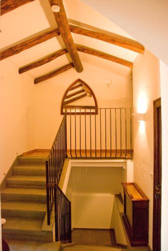 a staircase in a building with a wooden ceiling at San Francesco Resort in Agropoli