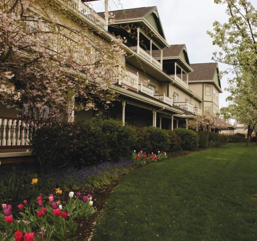 a large house with flowers in the yard at Carlisle Inn Walnut Creek in Walnut Creek